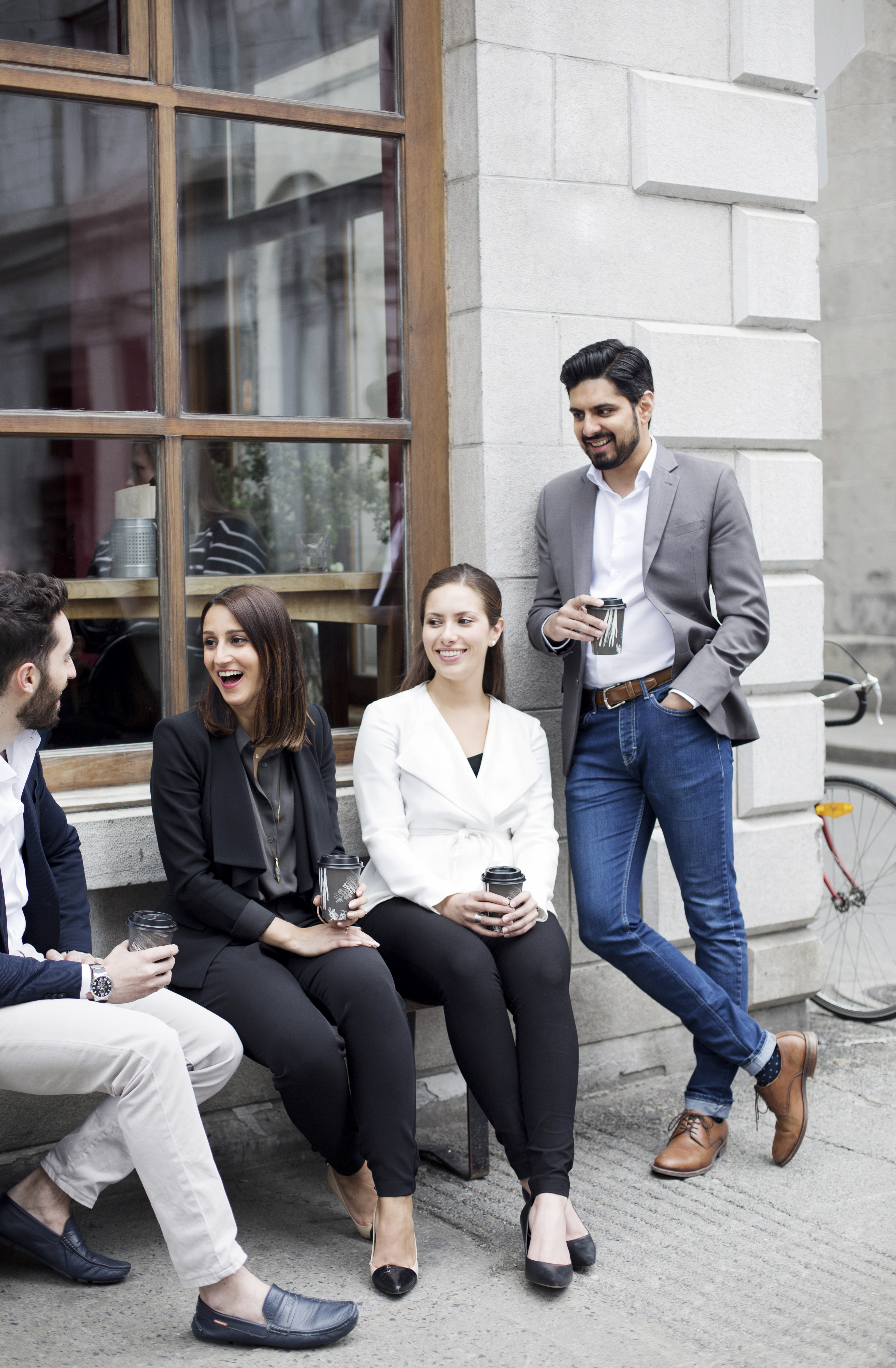 team members who achieved professional designations laughing and talking